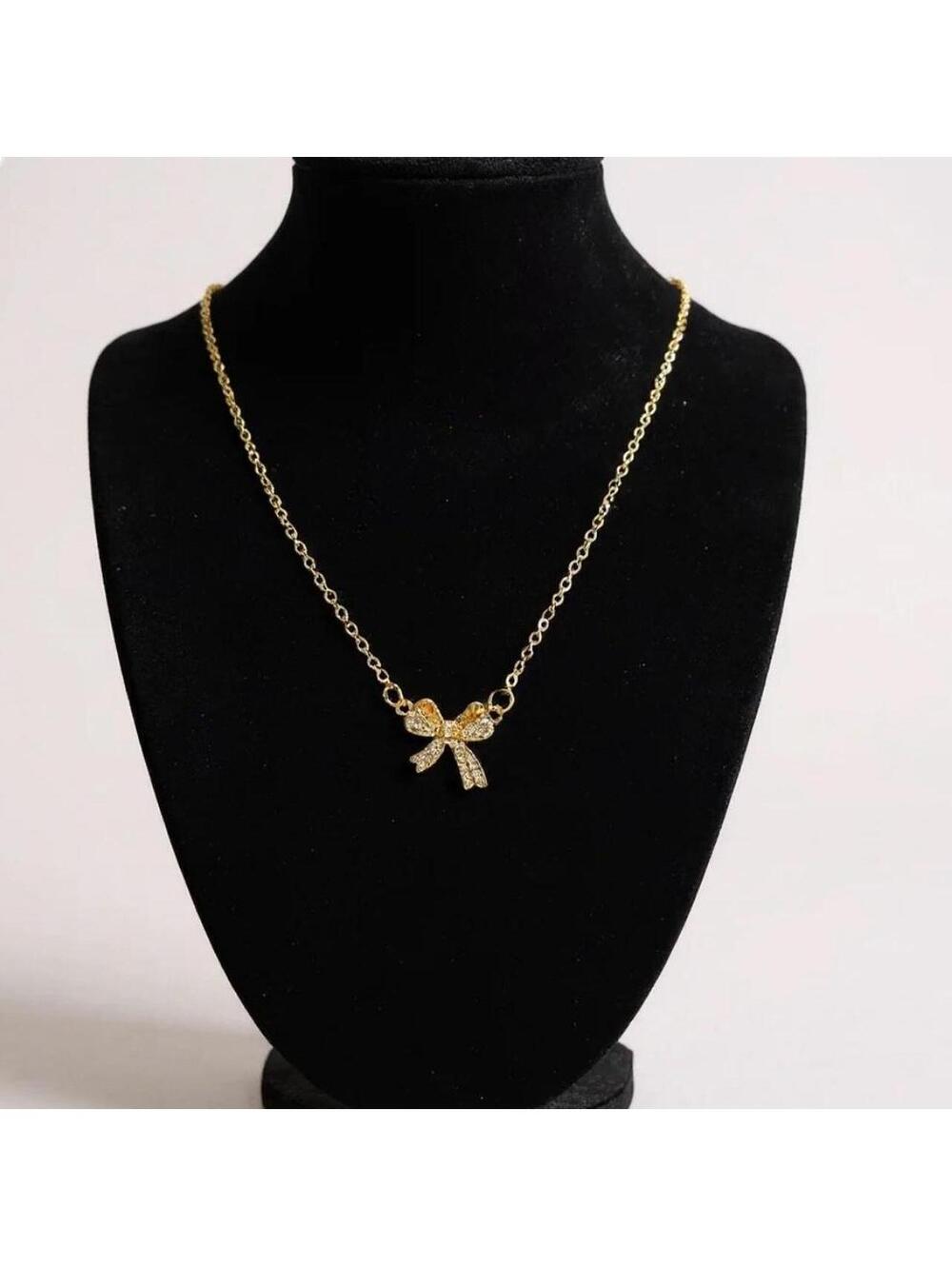 Gold Tone Bow Pendant Necklace with Rhinestones